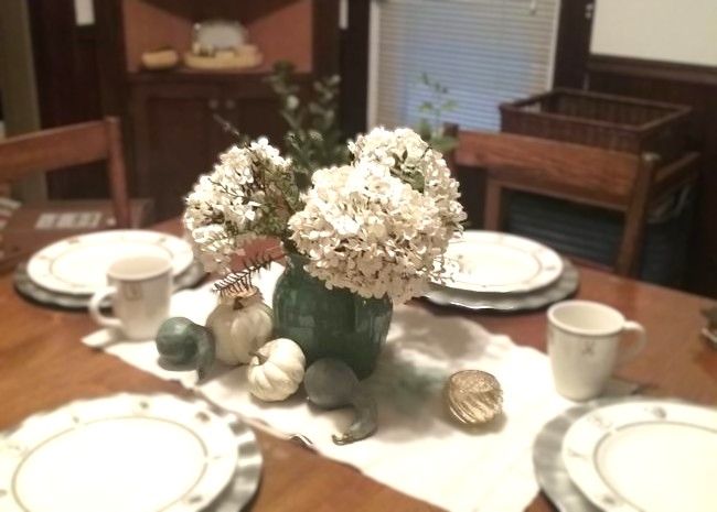 vintage pottery pitcher filled with faux hydrangea and mixed artificial greenery
